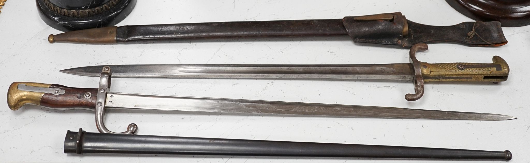 A French bayonet and scabbard with matching serial number (38804) and inscription and date to back of blade (1879) and another Solingen bayonet and scabbard
